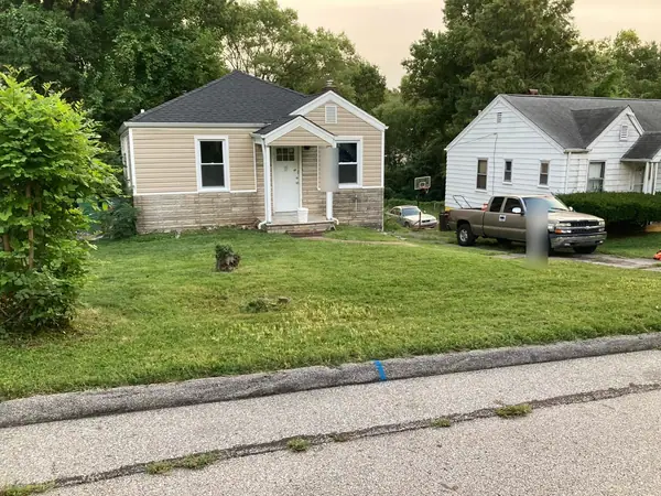 A tan-sided bungalow with the lawn cut back and the front tidied up.