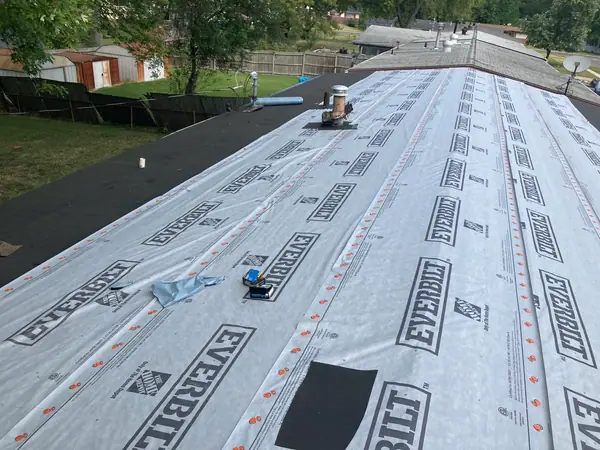 The same roof dried in: new decking down, synthetic underlayment rolled and capped, ice and water membrane run at the valley